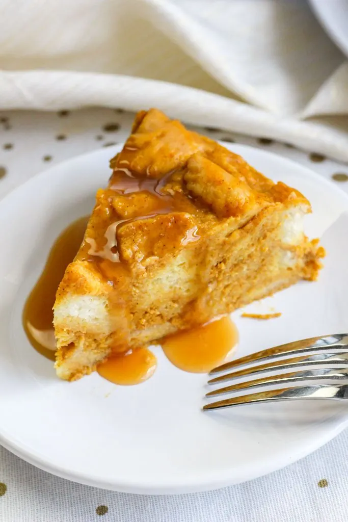A slice of Instant Pot Bread Pudding drizzled in syrup on a plate.