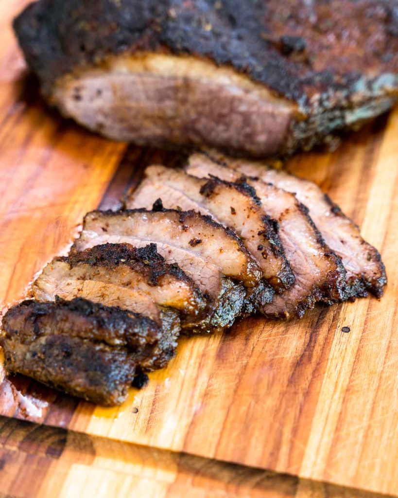 Slices of oven brisket recipe on a cutting board