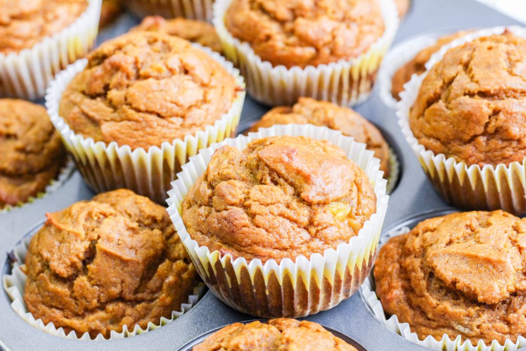 Top down view of muffins sitting on top of a mufiin tin