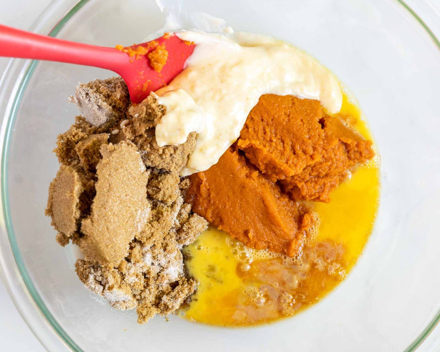 Wet ingredients for a pumpkin batter in a bowl.