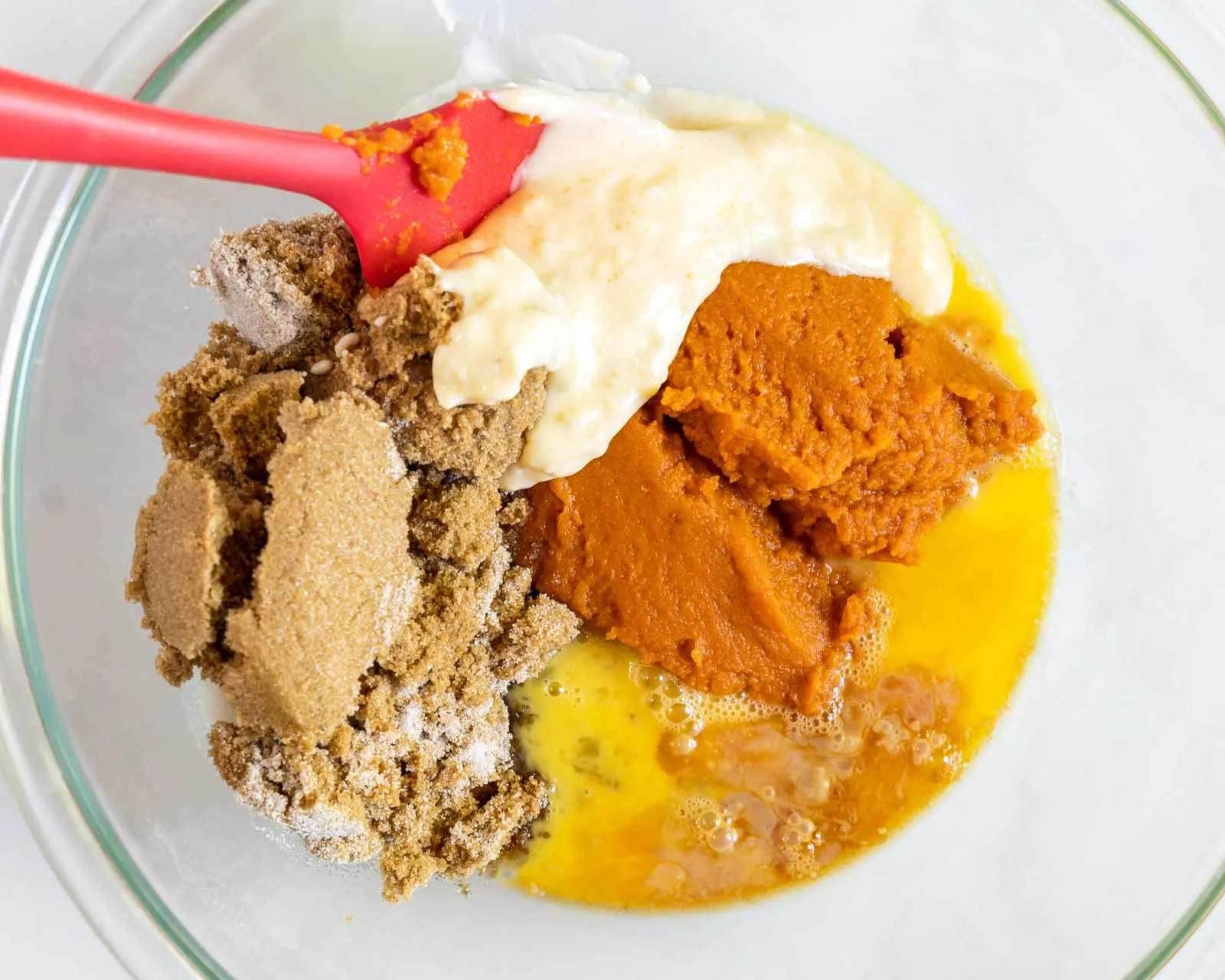 Wet ingredients for a pumpkin batter in a bowl.