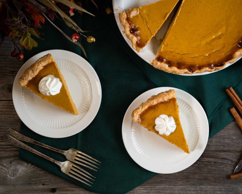Top down view of two slices of rich and creamy classic pumpkin pie.