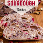 A sliced loaf of Sourdough filled with fresh cranberries and walnuts.