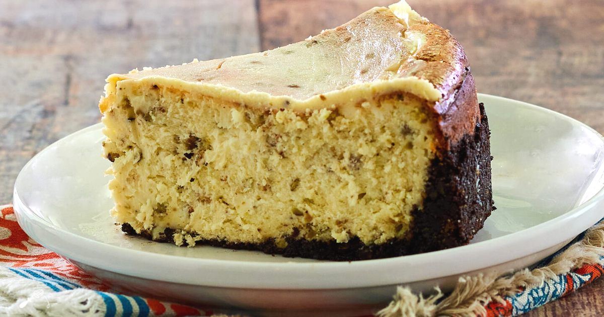 Side view of a slice of cheesecake stuffed with pistachios