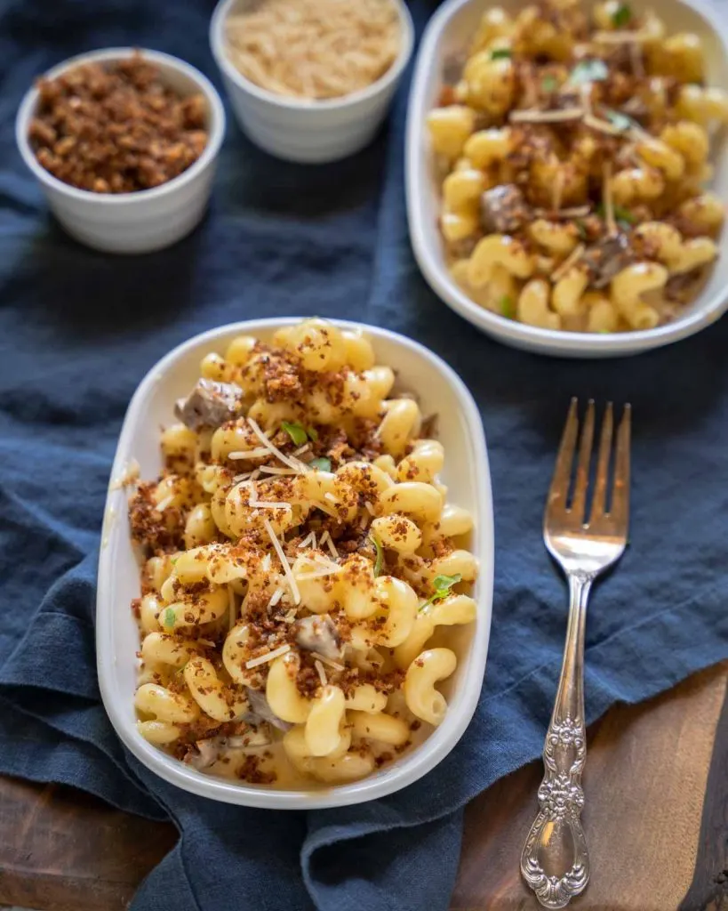 Top down view of a brisket pasta dish topped with breadcrumbs and cheese.