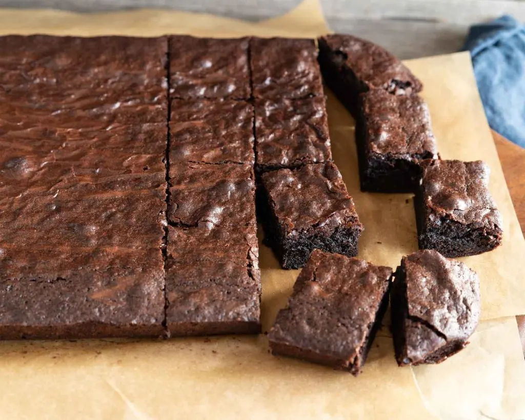 Angled view of chocolate brownies sliced into pieces.