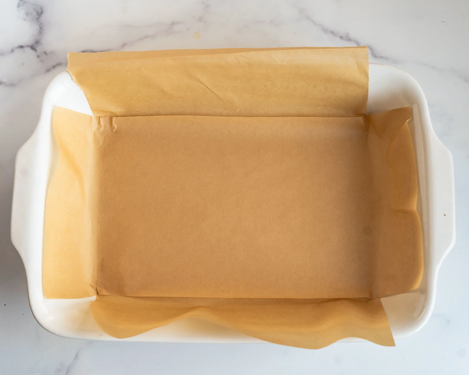 A baking dish lined with parchment paper