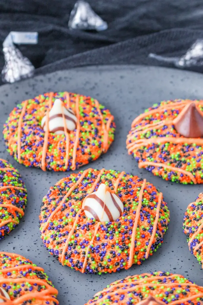 Brightly colored baked Hershey Kiss cookies for Halloween.