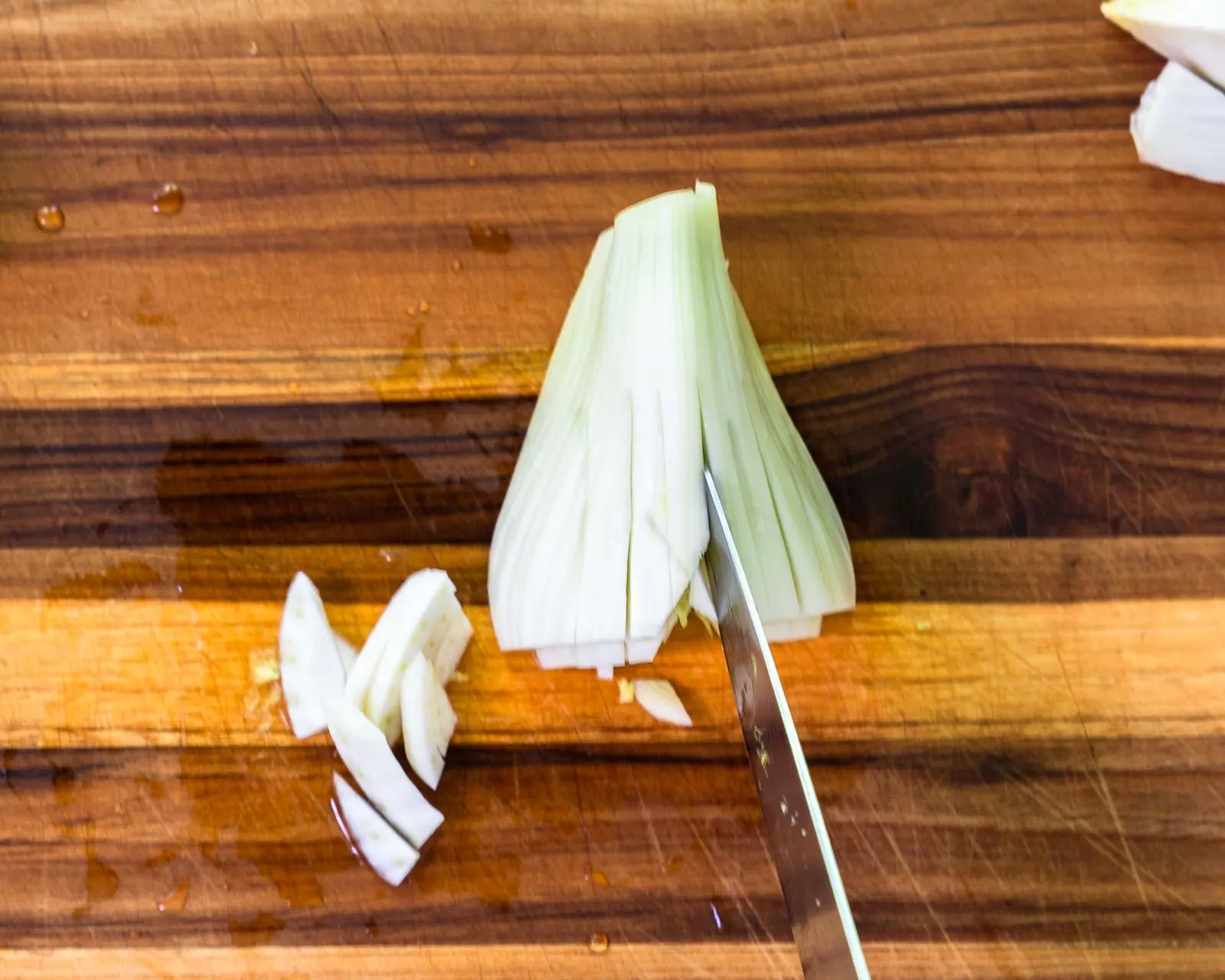 A piece of fennel cut in half and sliced vertically.