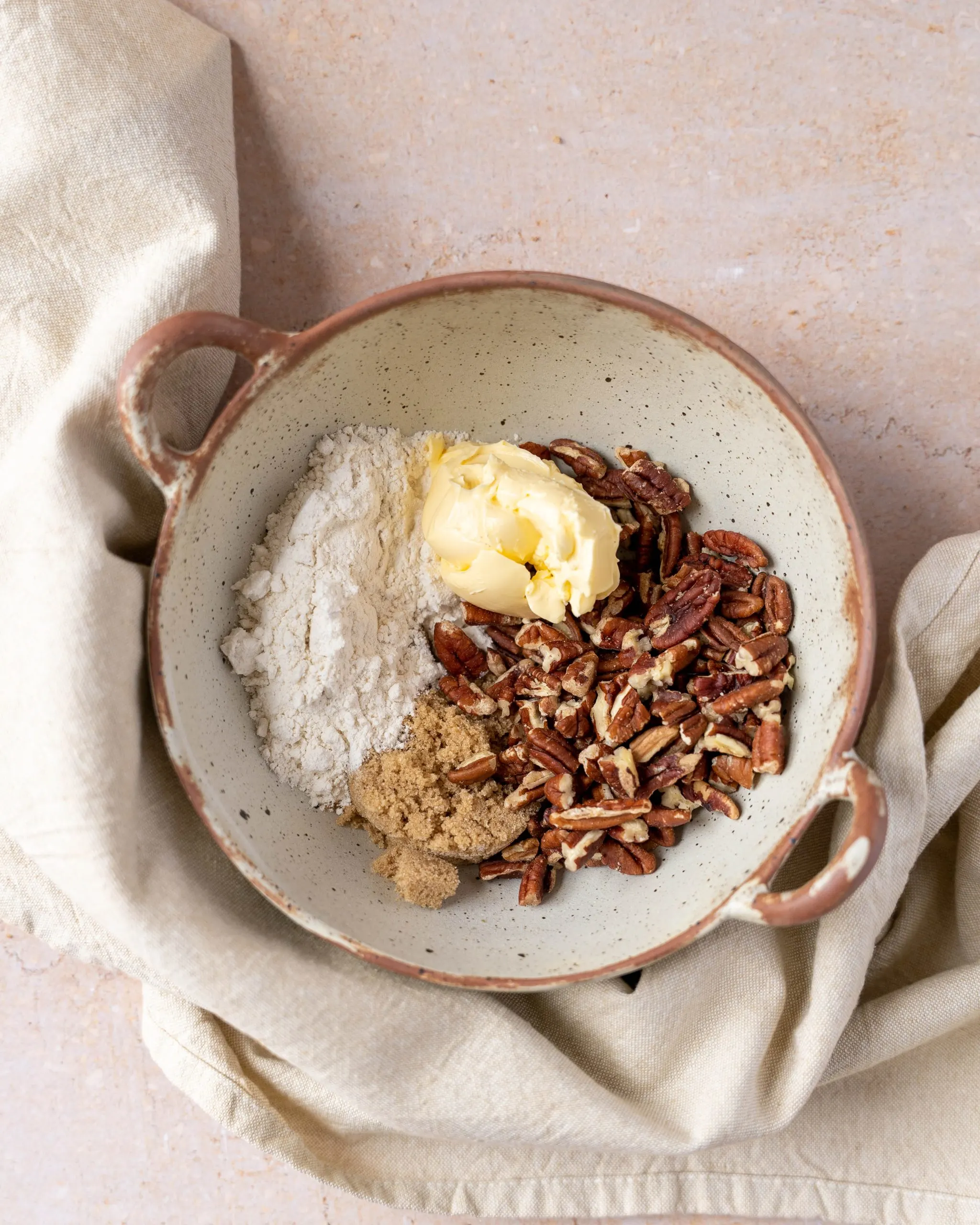 A bowl filled with ingredients to make streusel topping.