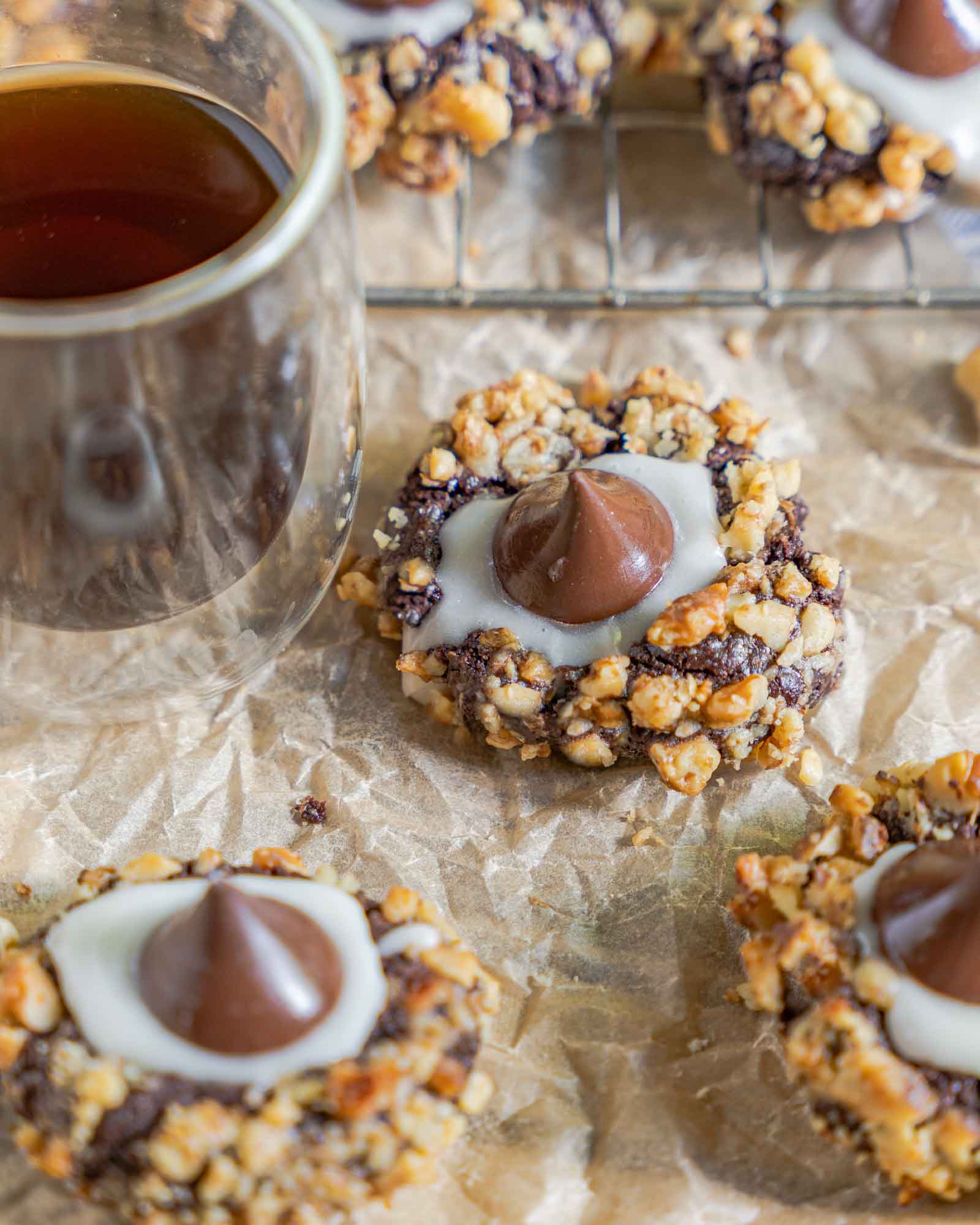 Angled view of three hershey's kiss cookies sitting on parchment paper