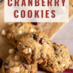 A stack of three oatmeal white chocolate cranberry cookies.