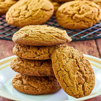 Side view of a stack of gingerbread cookies on a plate.