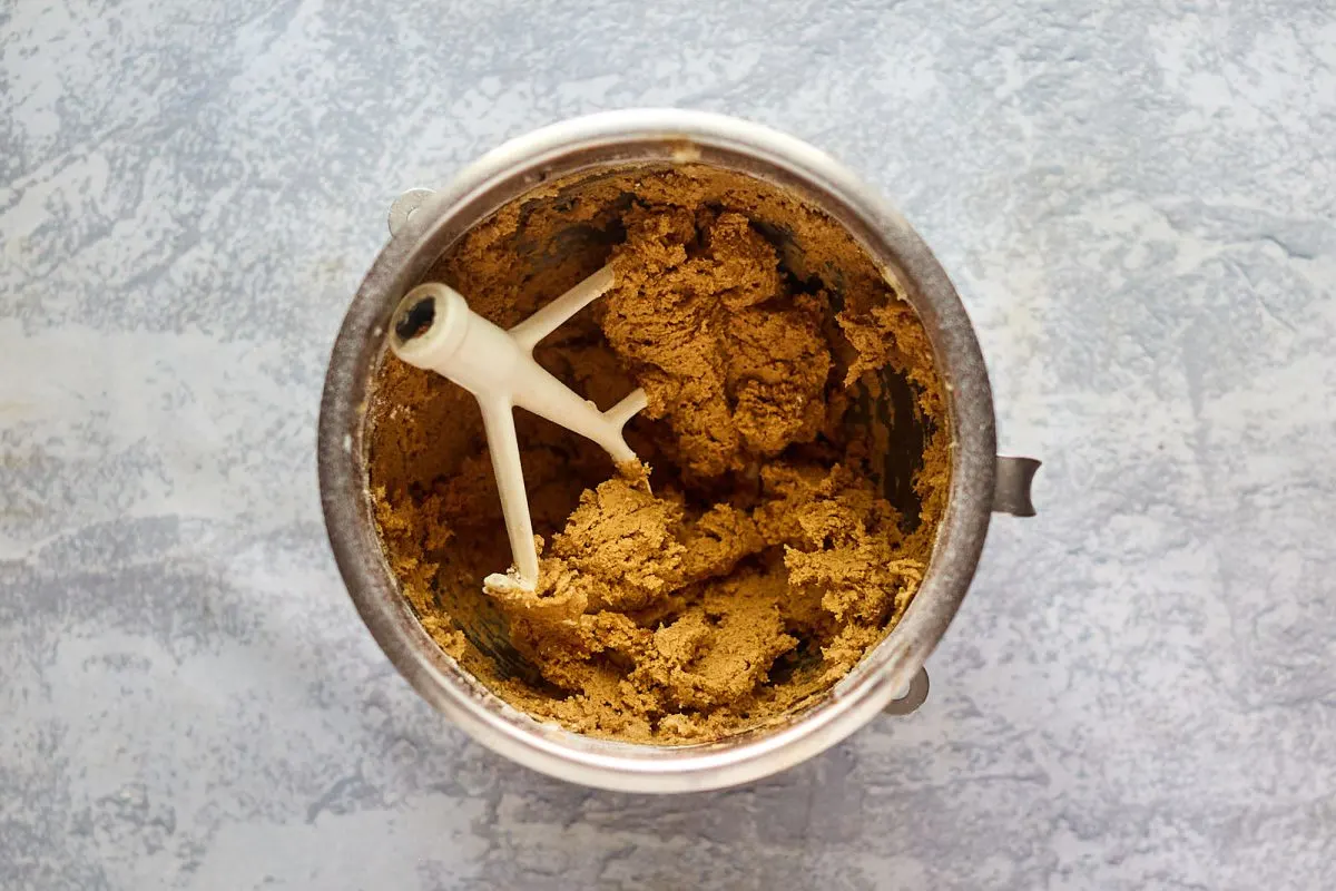 Thick gingerbread cookie batter in a bowl.