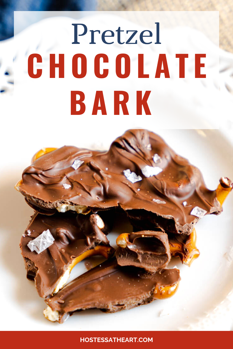 Pieces of Chocolate Bark Covered Pretzels sprinkled with sea salt sitting on a white plate. Hostess At Heart
