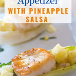 Side view of a cooked scallop sitting on top of pineapple salsa and drizzled with wasabi sauce - hostess at heart
