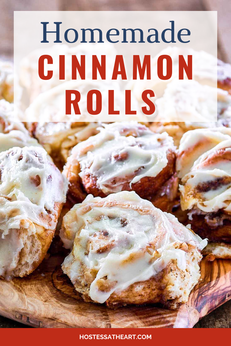Table view of homemade iced cinnamon rolls sitting on a cutting board - Hostess At Heart