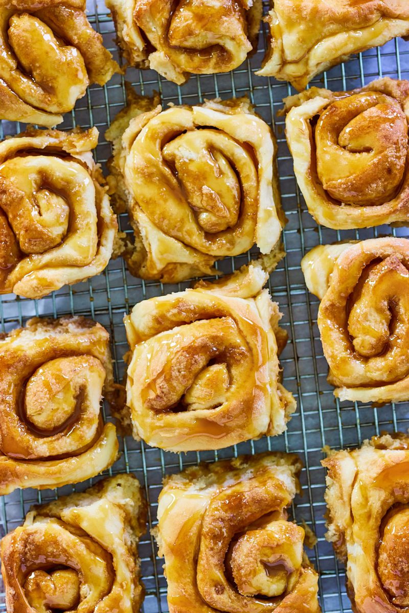 Top down view of Cinnamon Caramel Rolls sitting on a cooling rack. - Hostess At Heart