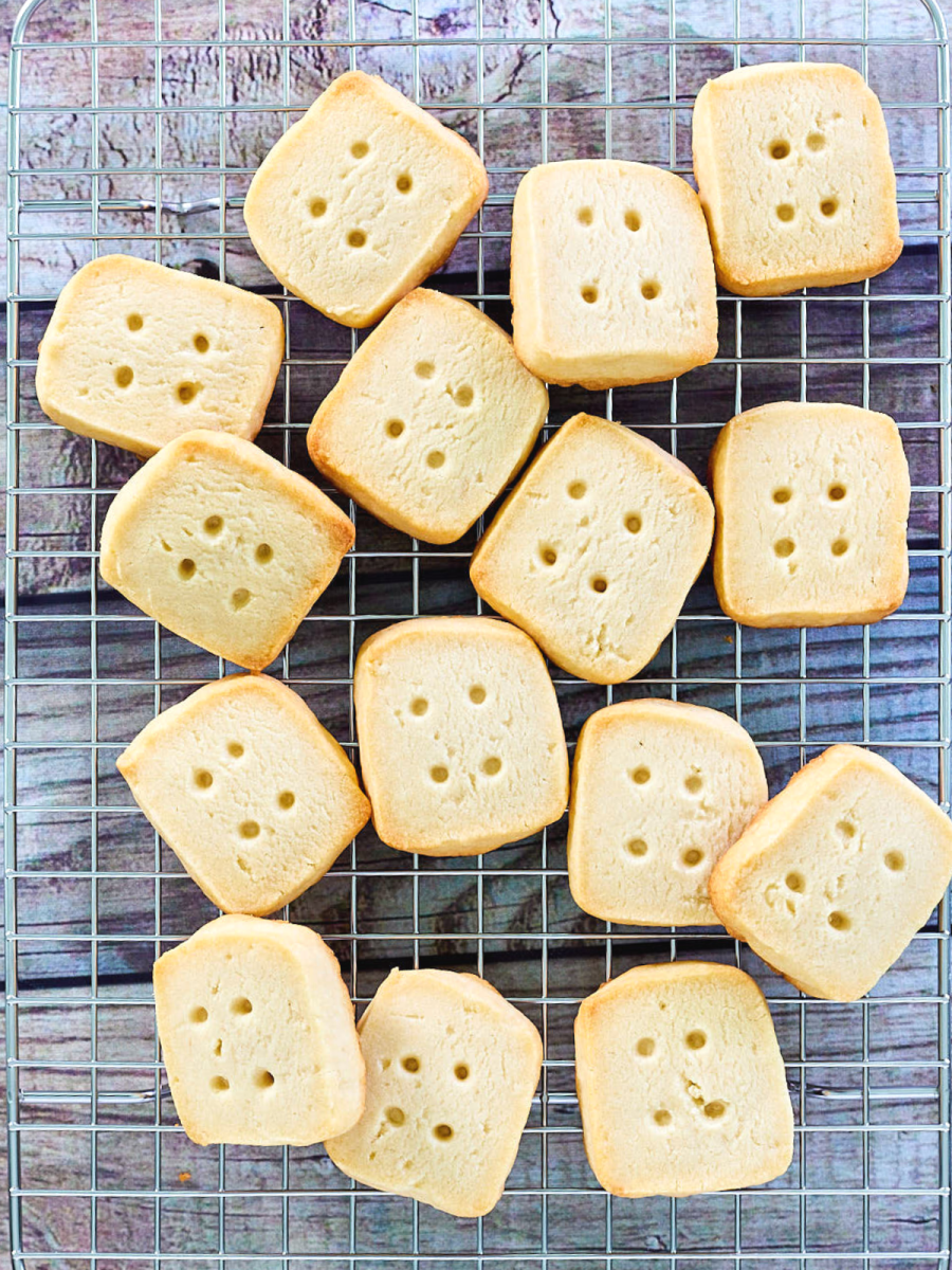 Top down view of short bread cookies cut into small squares to look like rustic buttons on a cooling rack - Hostess At Heart