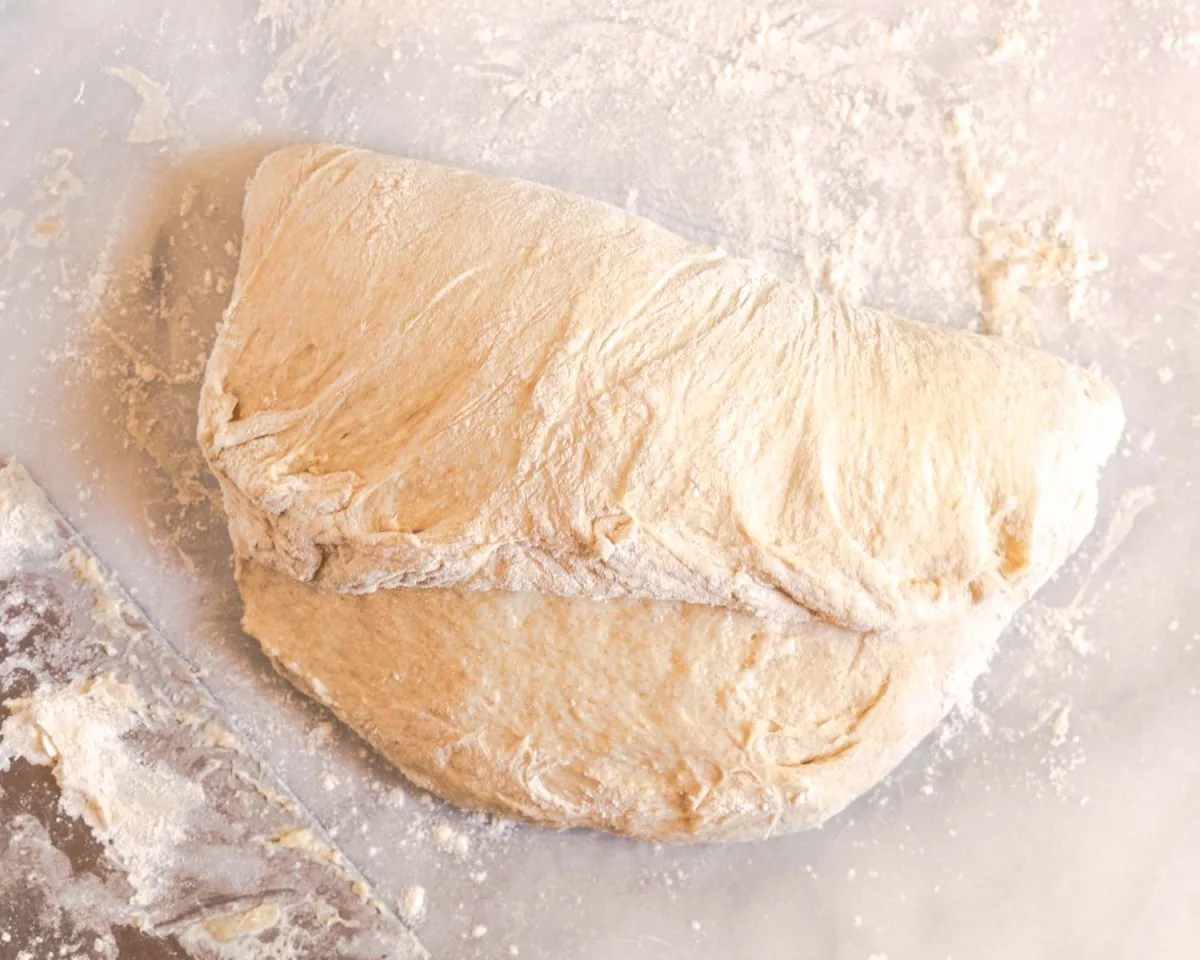 Bread dough that has had the top stretched from the top to the center.