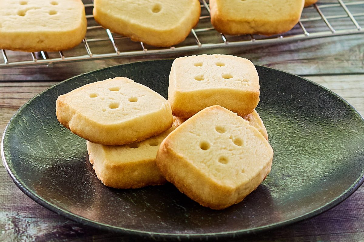 Close-up side view of shortbread Christmas cookies on a plate. Hostess At Heart