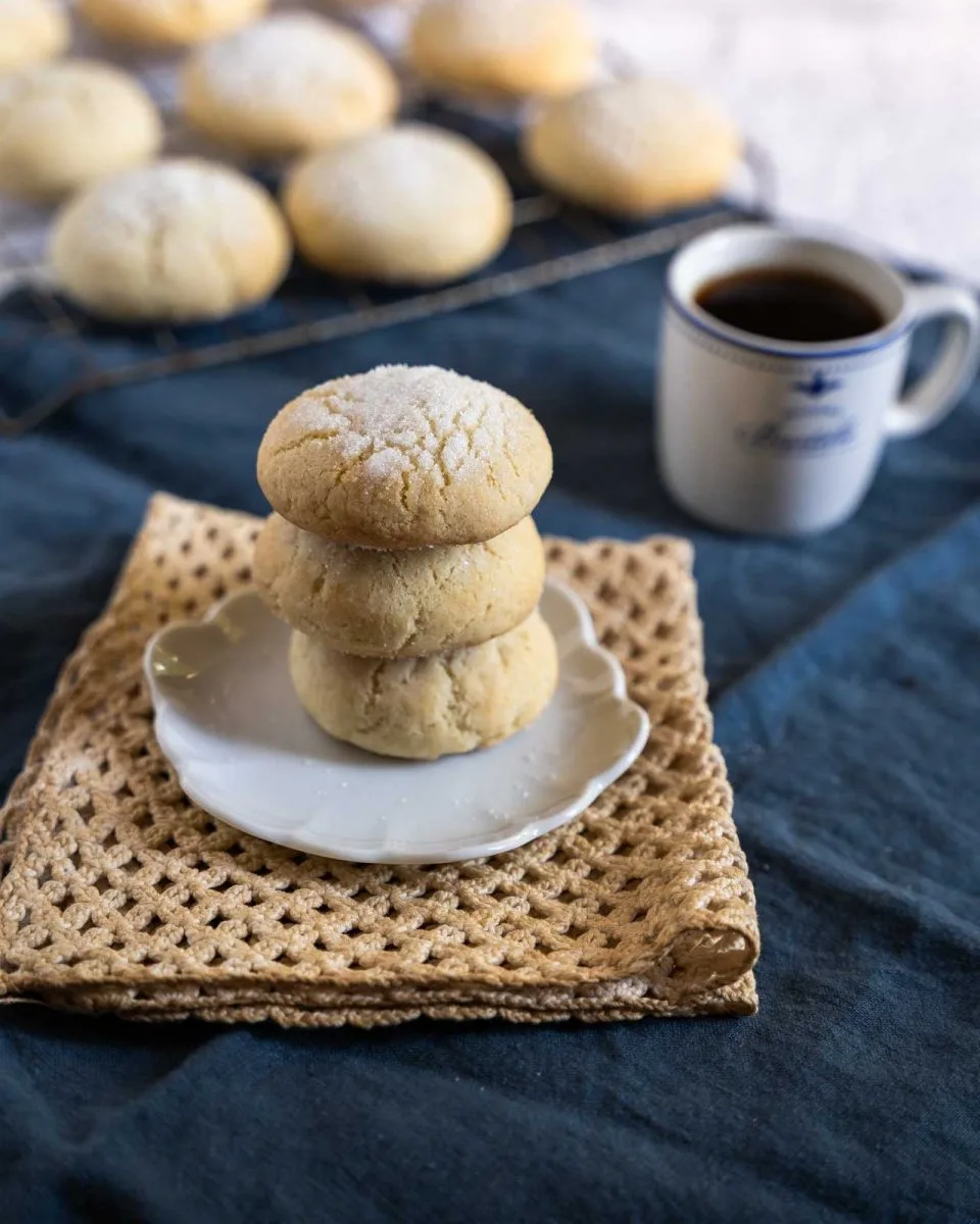 A stack of 3 sour cream sugar cookies sitting on a white plate - Hostess at Heart