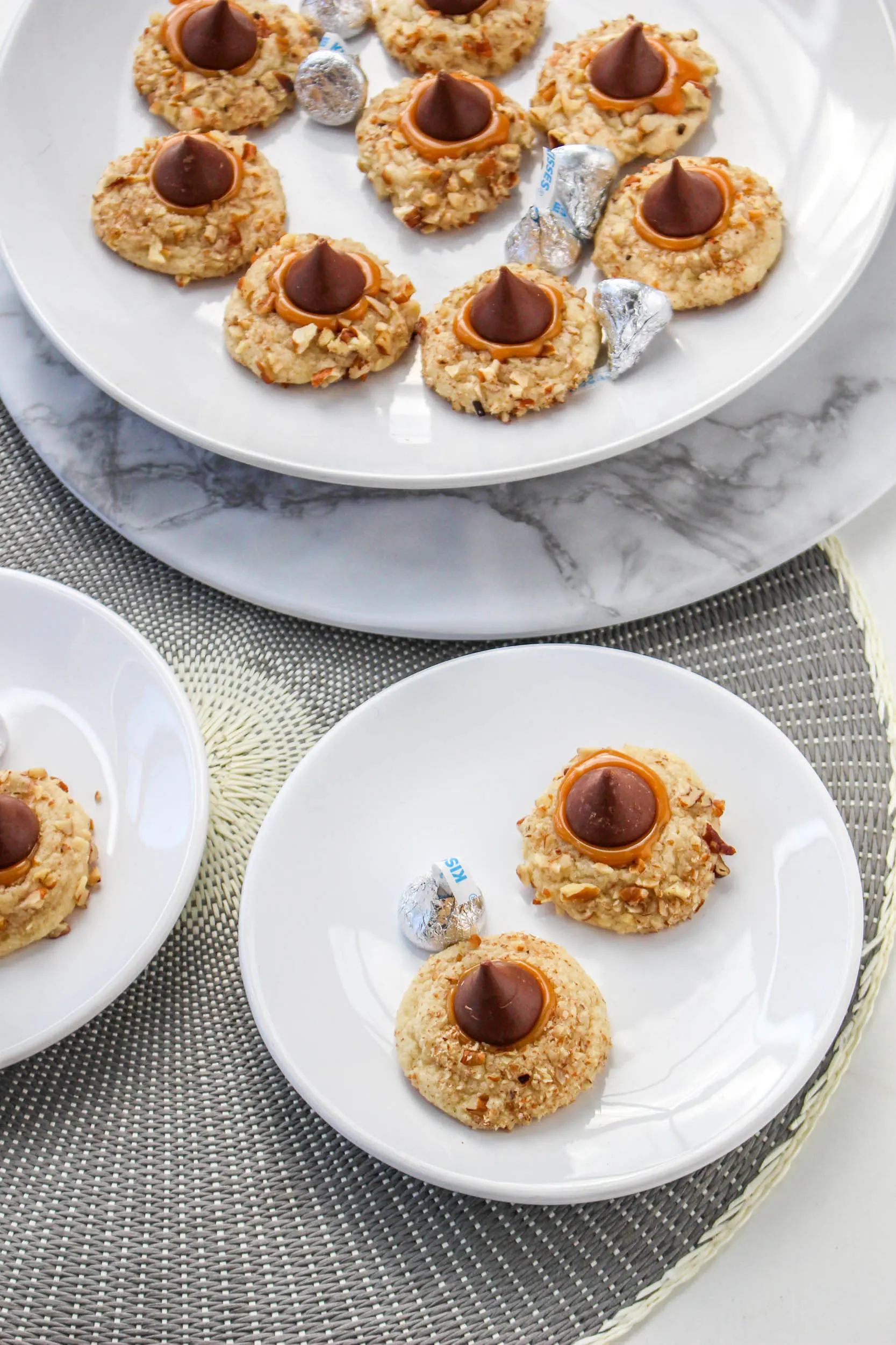 Top down view of turtle cookies sitting on serving plates - hostess at heart