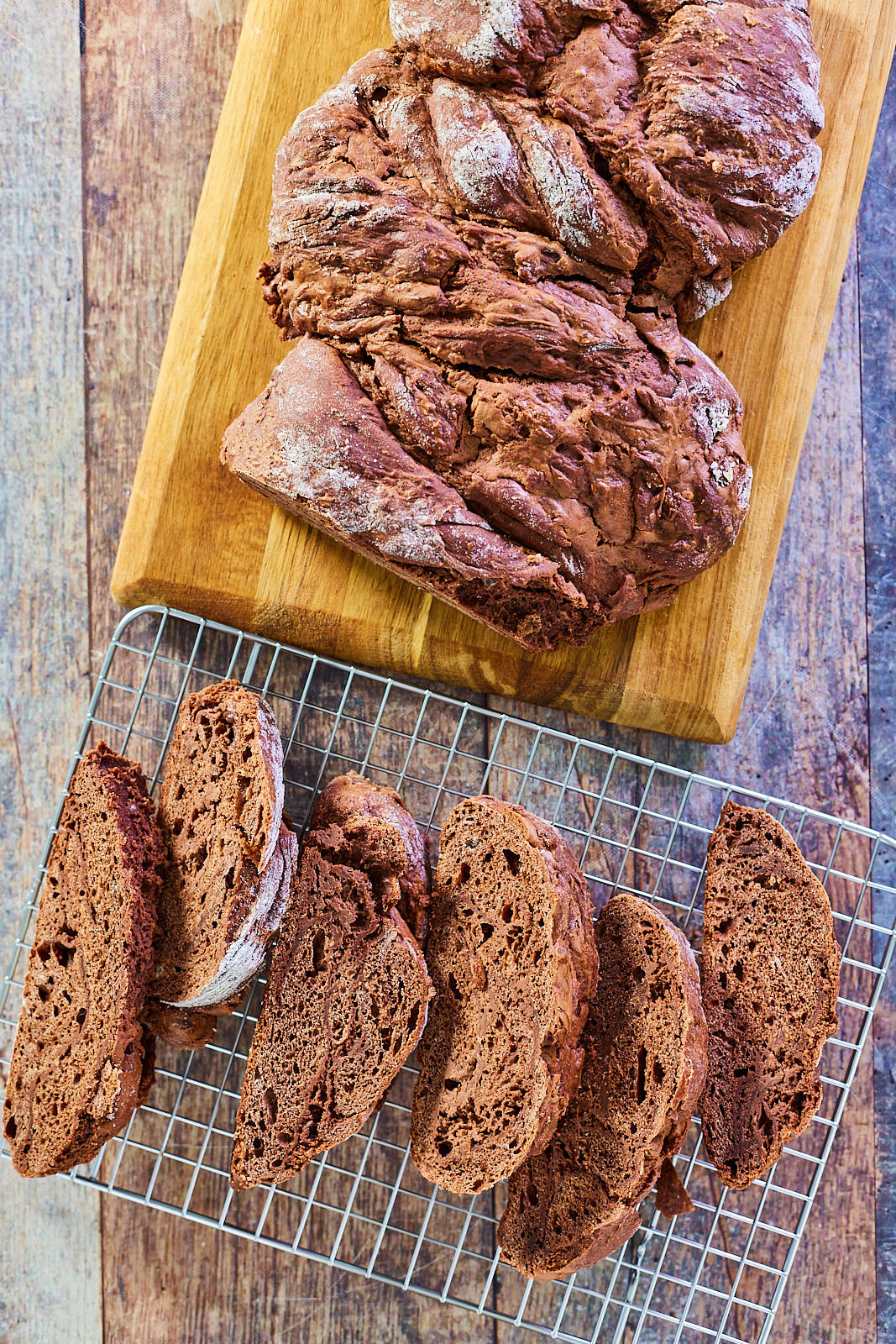 Top down view of a loaf of chocolate babka sliced on a cooling rack - Hostess At Heart