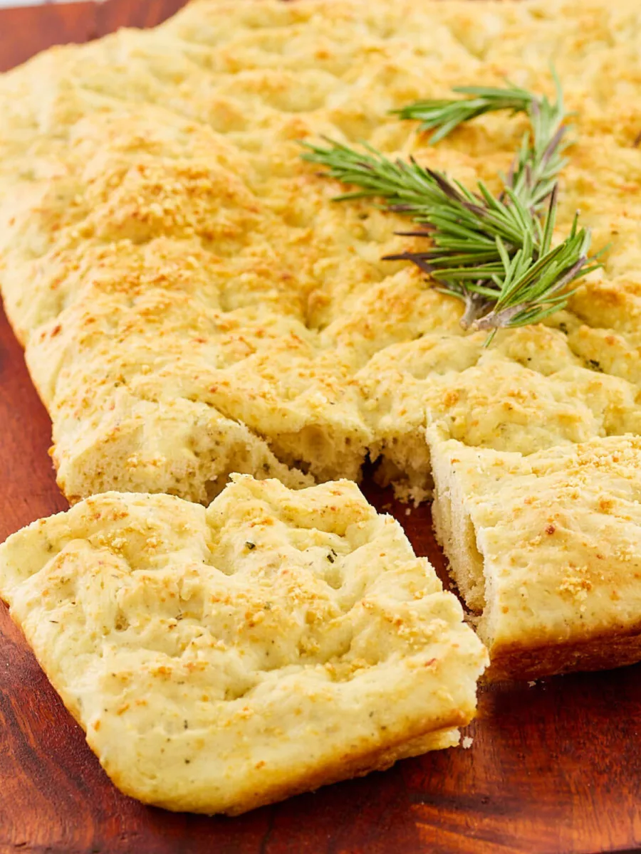 Close up view of a piece of focaccia bread cut from the loaf - Hostess At Heart.