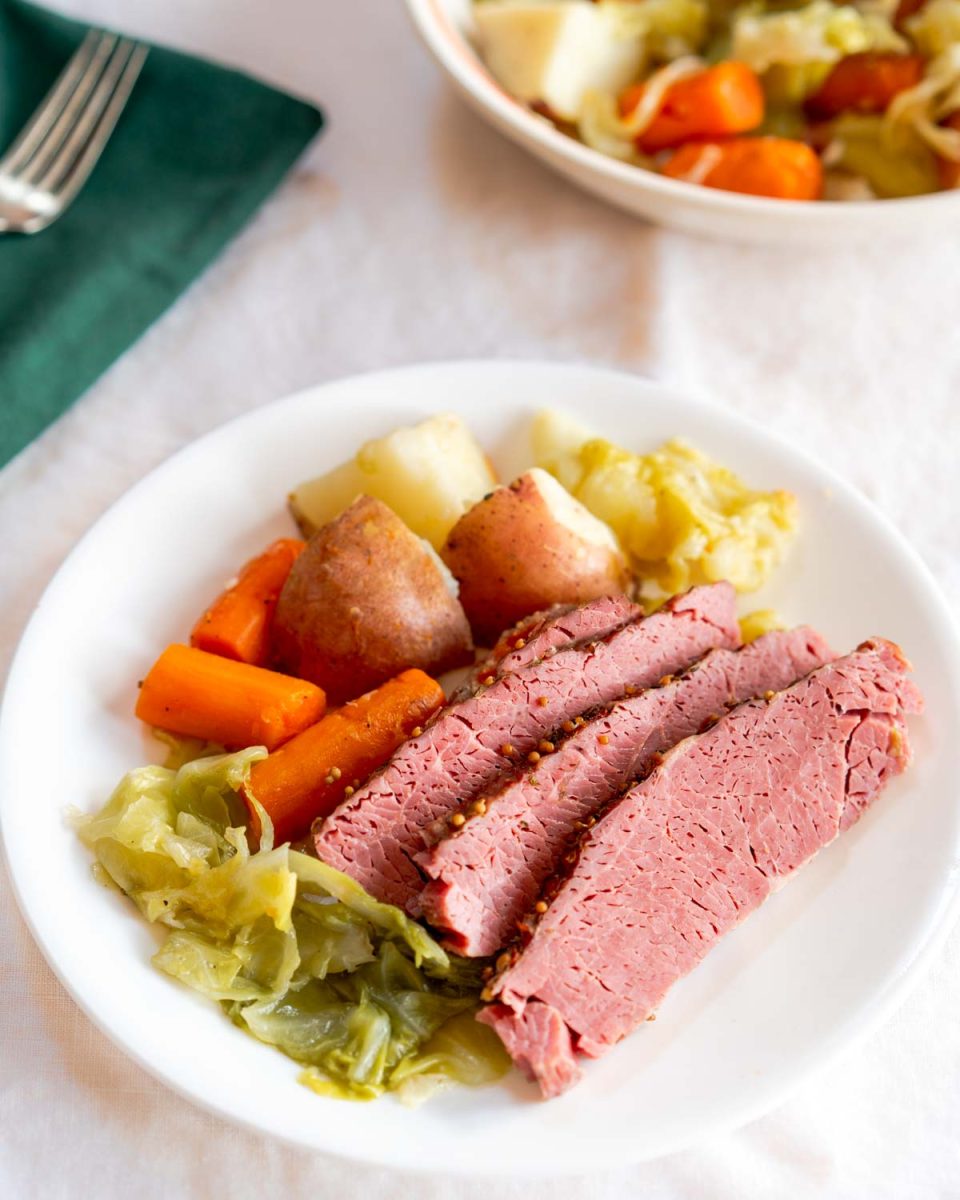 Top down view of a cooked instant pot brisket surrounded by cooked vegetables - Hostess A Heart