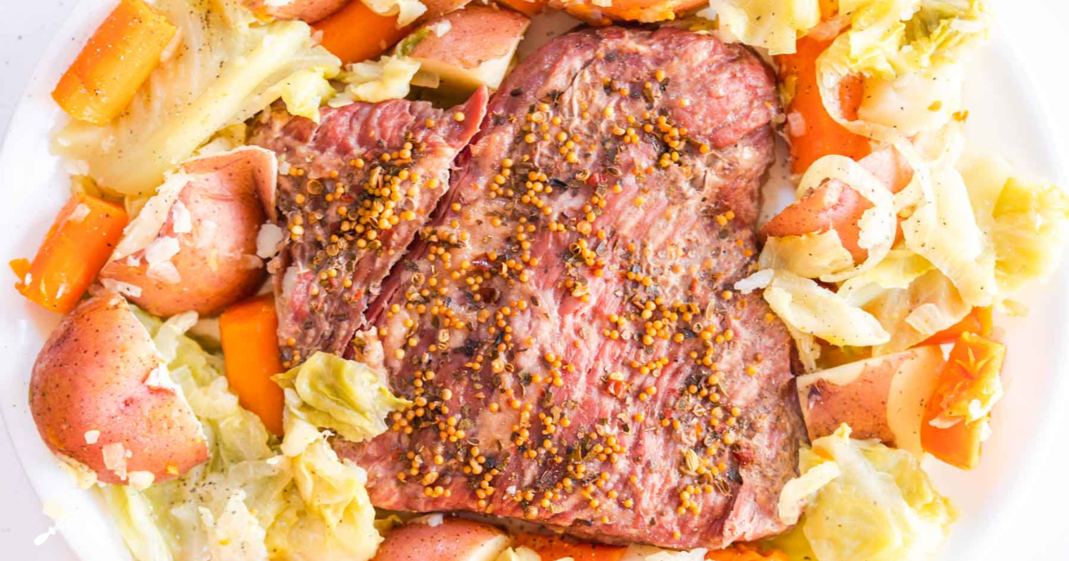 Top down view of a instant pot Corned Beef and Cabbage on a platter. Hostess At Heart