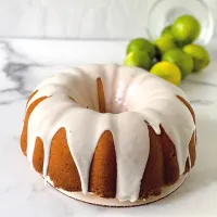 Side veiw of a keylime pound bundt cake topped with key lime glaze - hostess at heart