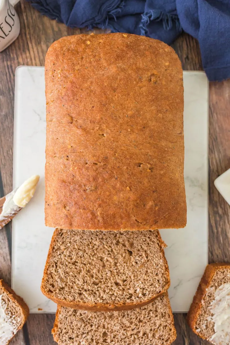 Top-down view of a sliced loaf of homemade whole grain bread