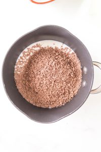 Grated Chocolate combined with milk in a saucepan - Hostess At Heart