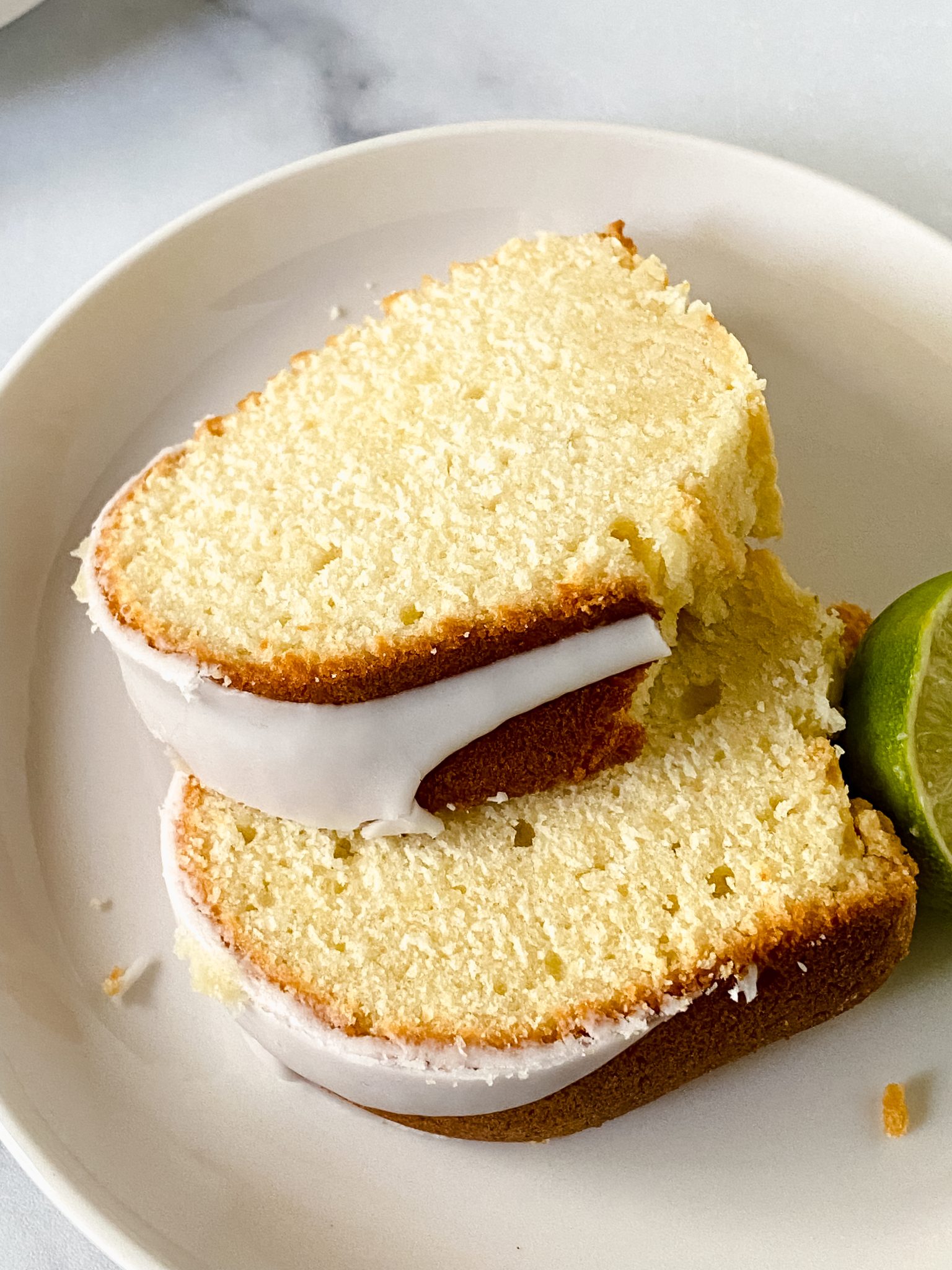 Angled view of keylime bundt cake slices topped with glaze - Hostess At Heart