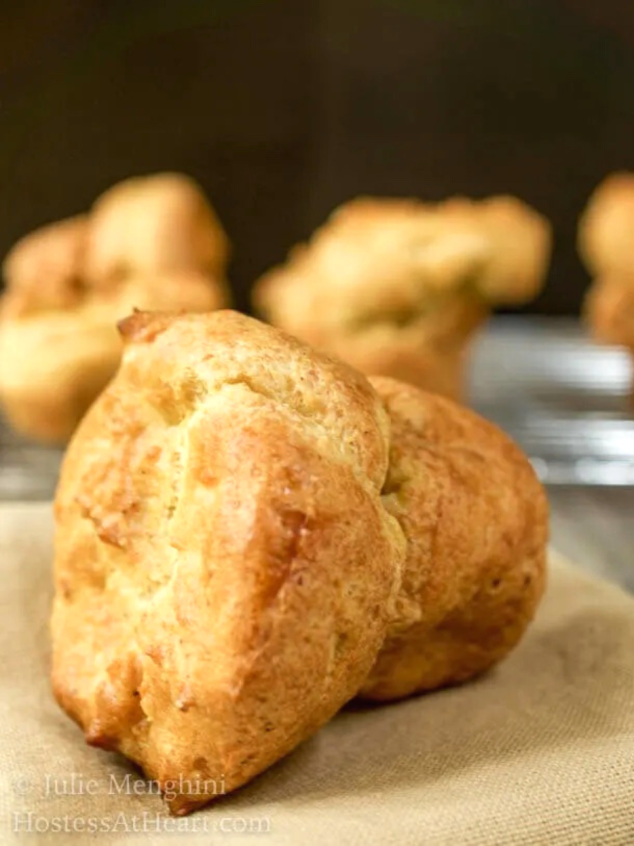 Tableview of a baked golden brown Passover popover laying on its side. Hostess At Heart