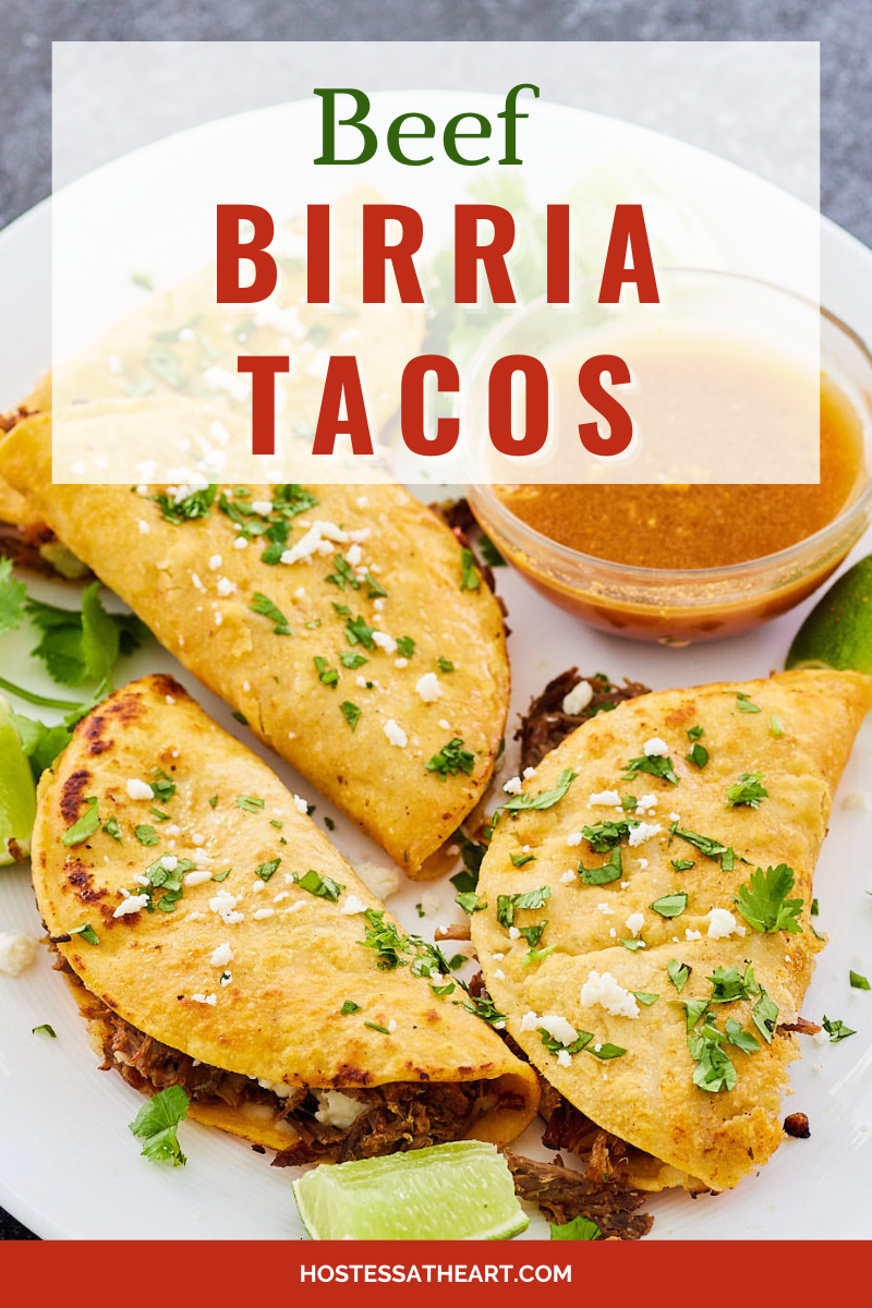 Top down view of beef tacos sitting on a plate garnished with chopped cilantro and cheese.