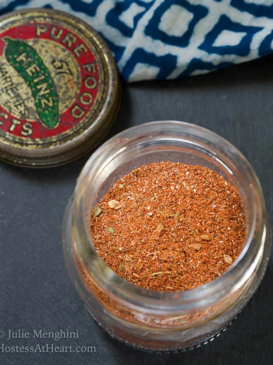 Top down view of a glass jar filled with blackening seasoning spices - Hostess At Heart