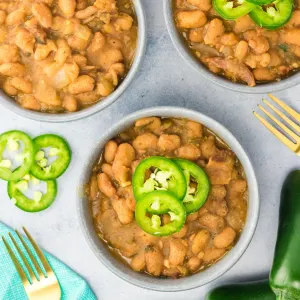 Top down view of bowls filled with Charro Beans topped with jalapeno slices - Hostess At Heart