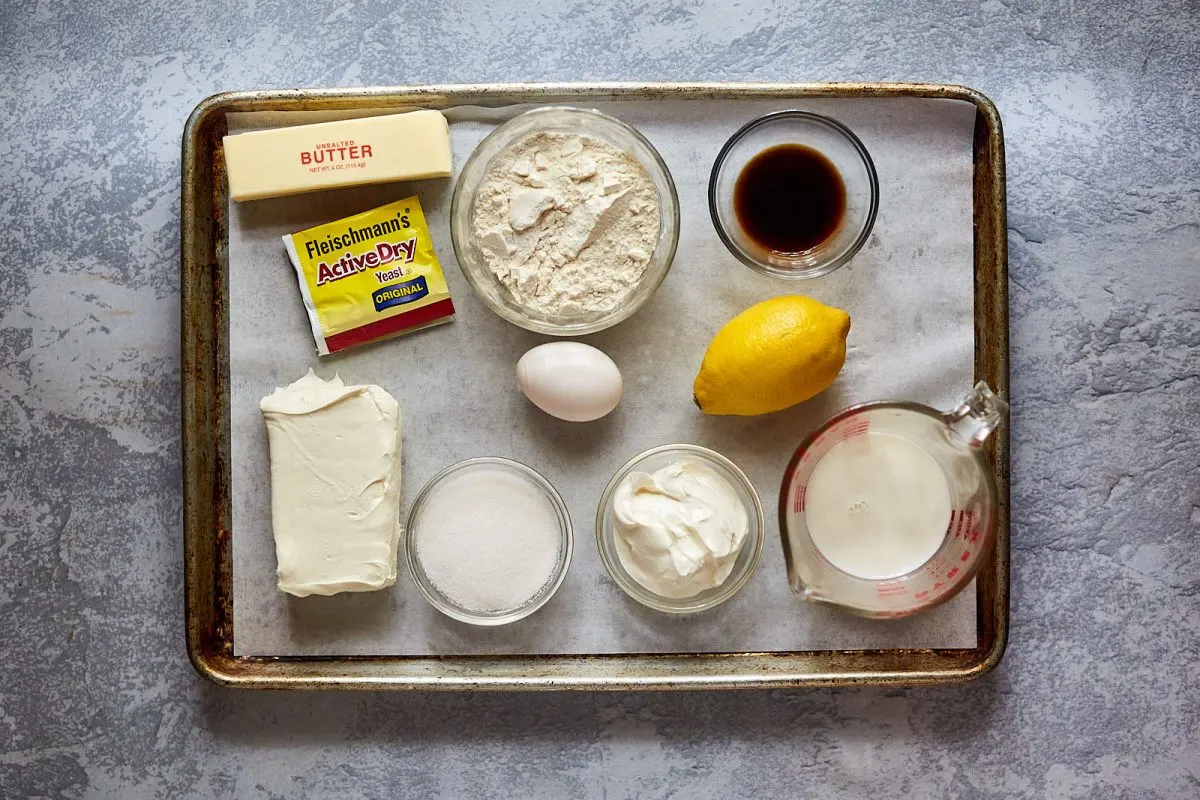 Ingredients for Polish Babka Bread including yeast, cream cheese, egg, lemon, milk, butter, sugar, and vanilla extract.
