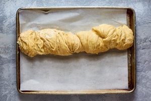 Dough rolled and twisted into a rope on a baking sheet - Hostess At Heart