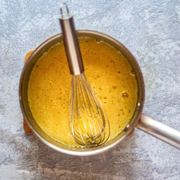 Top down view of a custard cooking in a saucepan - Hostess At Heart