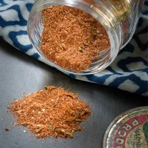 Close-up view of a glass jar tipped on it's side allowing spices to spill out - hostess at heart