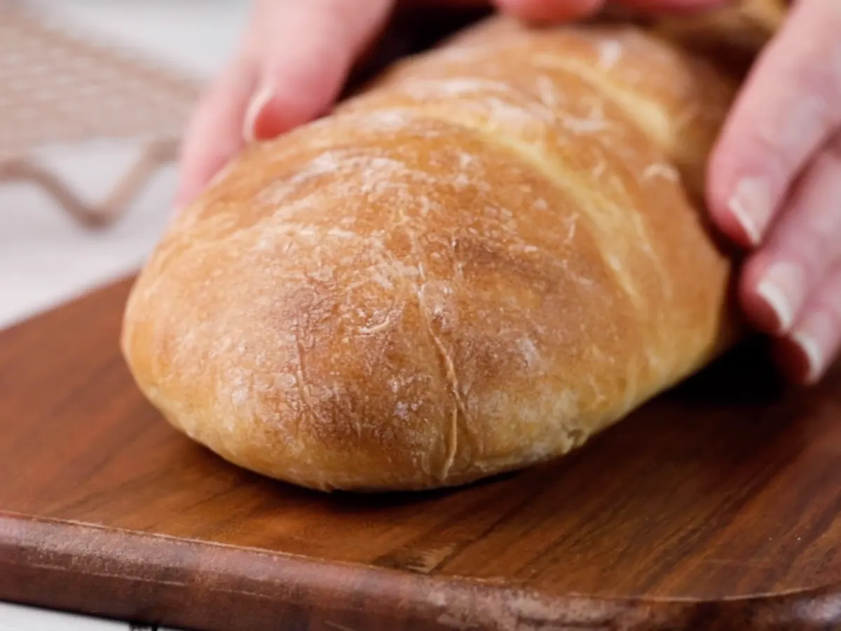 Front view of a loaf of homemade Italian bread sitting on a cutting board - Hostess At Heart