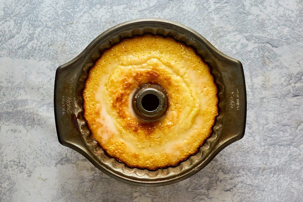 Top-down view of a cake baked in a bunt pan topped with lemon glaze - Hostess At Heart
