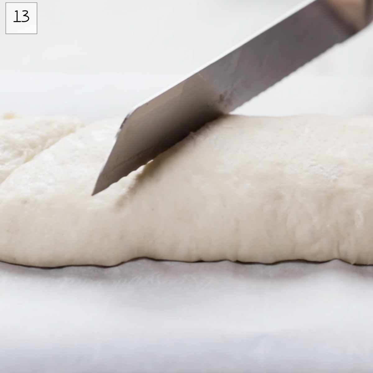 A knife scoring a loaf of bread. Hostess At Heart