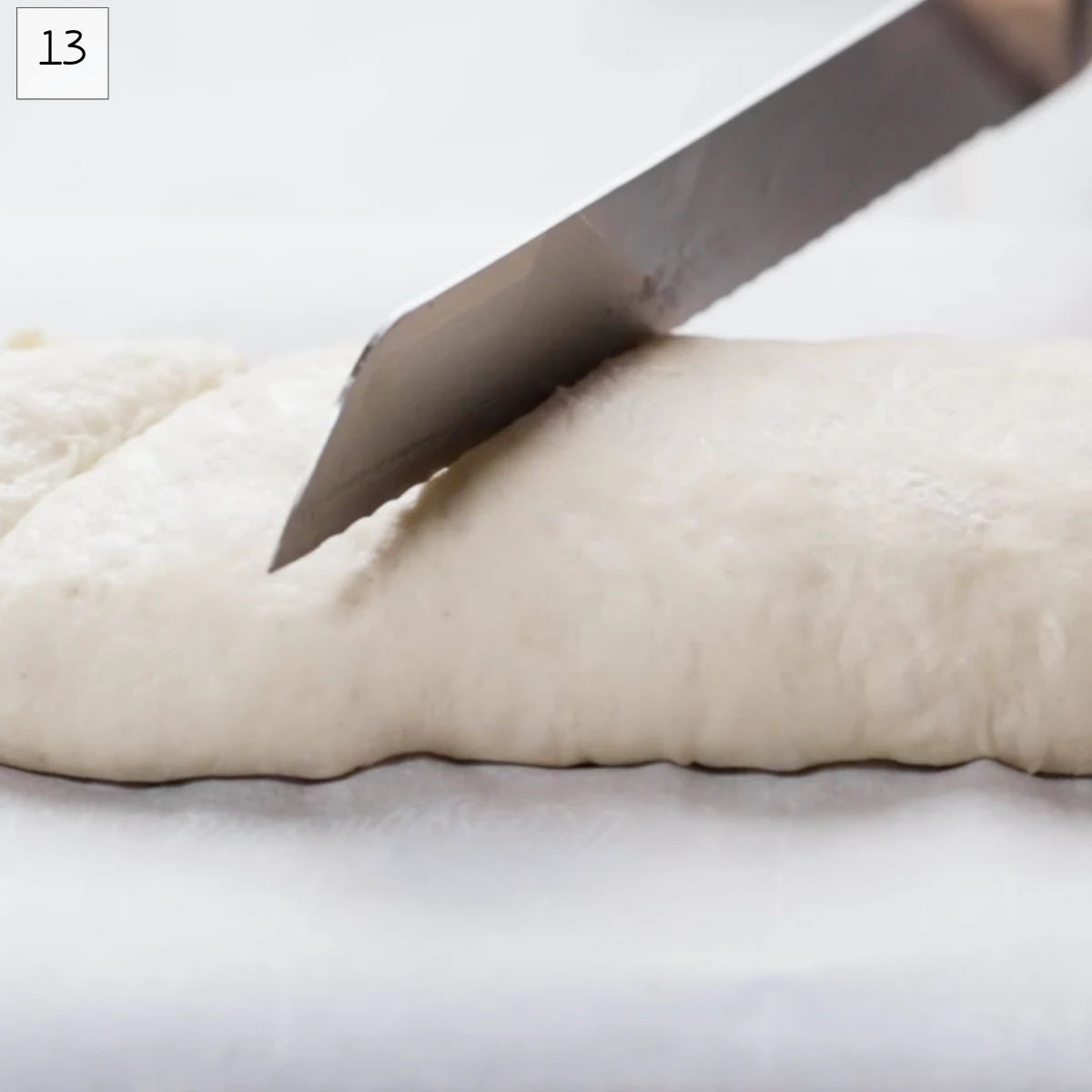 A knife scoring a loaf of bread. Hostess At Heart