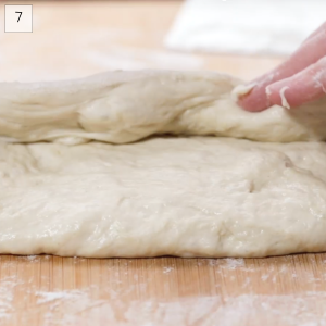 Top half of bread dough folded over the bottom half in order to shape it into a batard - Hostess At Heart