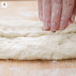 Bread dough being folded ontop of itself in order to shape it into an Italian Loaf of Bread - Hostess At Heart