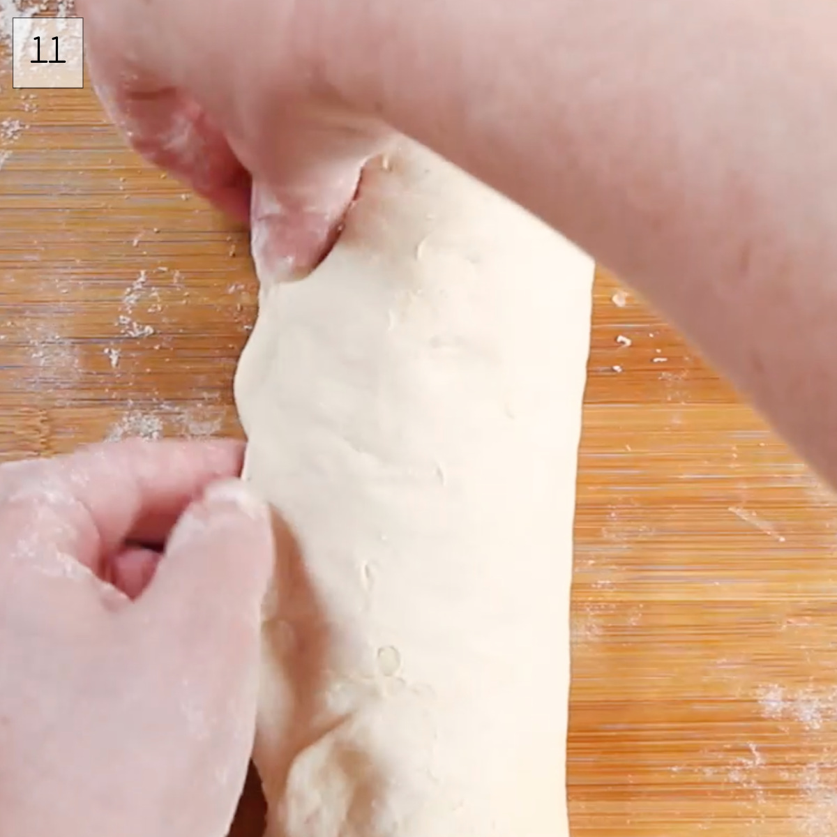 Bread dough pulled tight and pinched on the long edge in order to shape a crusty loaf of bread - Hostess At Heart